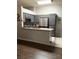 Modern kitchen features stainless steel appliances, gray cabinets, and breakfast bar seating at 1367 Sun Pillars Ave, Henderson, NV 89014