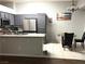 Modern kitchen featuring gray cabinets, stainless steel appliances, and a breakfast bar with a cozy dining area at 1367 Sun Pillars Ave, Henderson, NV 89014