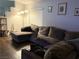 Cozy living room featuring a comfortable sofa, wood floors, and natural light, ideal for relaxation at 1367 Sun Pillars Ave, Henderson, NV 89014