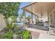 Inviting backyard featuring a covered patio, lush landscaping, and outdoor seating at 1667 Sabatini Dr, Henderson, NV 89052