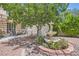 Charming backyard with a water fountain feature surrounded by mature trees and landscaping at 1667 Sabatini Dr, Henderson, NV 89052