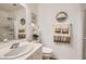 Clean bathroom with a sink, decorative mirrors, updated fixtures, and glass door walk-in shower at 1667 Sabatini Dr, Henderson, NV 89052