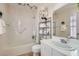 Clean bathroom with a shower/tub combo, decorative accents, and white cabinetry at 1667 Sabatini Dr, Henderson, NV 89052