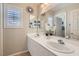 Bright bathroom boasts dual sinks, white cabinetry, and stylish decor with ample natural light at 1667 Sabatini Dr, Henderson, NV 89052