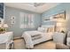 Stylized bedroom with natural light, white shutters, comfortable bed and decorative artwork at 1667 Sabatini Dr, Henderson, NV 89052