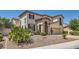 Inviting two-story stucco home with a tile roof, desert landscaping, and a private gated entrance at 1667 Sabatini Dr, Henderson, NV 89052