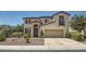 Beautiful two-story home showcasing a private entry, low-maintenance desert landscaping, and an attached garage at 1667 Sabatini Dr, Henderson, NV 89052