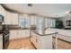 Bright kitchen features granite countertops, stainless steel appliances, a central island, and an adjacent living area at 1667 Sabatini Dr, Henderson, NV 89052