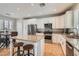 Gourmet kitchen with granite countertops, white cabinetry, and a stainless steel appliance package at 1667 Sabatini Dr, Henderson, NV 89052