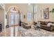 Bright living room with high ceilings, large windows, and a stylish seating arrangement, perfect for relaxation at 1667 Sabatini Dr, Henderson, NV 89052