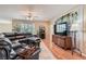 Spacious living room features plush leather seating, wood floors, and bright window views at 1667 Sabatini Dr, Henderson, NV 89052