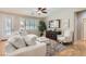 Bright living room featuring a cozy white couch, modern ceiling fan and a view of the outdoor patio at 1667 Sabatini Dr, Henderson, NV 89052