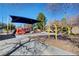 Community playground area with swings, slides, and sun shade canopy for children to enjoy at 1667 Sabatini Dr, Henderson, NV 89052