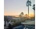 Scenic sunset view overlooking the pool and neighborhood with multiple palm trees at 1667 Sabatini Dr, Henderson, NV 89052