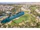 Scenic aerial view featuring a pond and sections of the well-manicured golf course in a vibrant community at 190 Tall Ruff Dr, Las Vegas, NV 89148