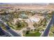 Stunning aerial view of the community clubhouse and pool, surrounded by palm trees and desert landscape at 190 Tall Ruff Dr, Las Vegas, NV 89148