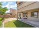 Landscaped backyard featuring a small lawn, garden, patio, and a view of the house's architecture at 190 Tall Ruff Dr, Las Vegas, NV 89148