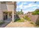 Desert landscaped backyard featuring a small lawn area, patio, and a desert landscape at 190 Tall Ruff Dr, Las Vegas, NV 89148