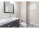 Modern bathroom vanity with black cabinets and white sink, as well as decorative tile flooring at 190 Tall Ruff Dr, Las Vegas, NV 89148