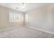 Bright bedroom with neutral walls, baseboard trim, plush carpeting, and plantation shutters at 190 Tall Ruff Dr, Las Vegas, NV 89148