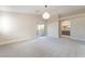 Open bedroom with neutral colors and access to a bathroom and balcony at 190 Tall Ruff Dr, Las Vegas, NV 89148