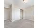 Neutral bedroom featuring a closet with sliding doors and soft, neutral-colored carpeting at 190 Tall Ruff Dr, Las Vegas, NV 89148