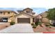 Two-story home featuring a two car garage, neutral color palette, and low maintenance landscaping at 190 Tall Ruff Dr, Las Vegas, NV 89148