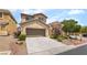 Two-story home featuring a two car garage, neutral color palette, and low maintenance landscaping at 190 Tall Ruff Dr, Las Vegas, NV 89148