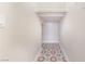 Hallway with decorative tile and a shelf for storage at 190 Tall Ruff Dr, Las Vegas, NV 89148