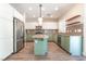 Bright kitchen with stainless steel appliances, white cabinets, a central island and granite countertops at 190 Tall Ruff Dr, Las Vegas, NV 89148