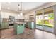 Spacious kitchen featuring granite countertops, stainless steel appliances, and access to the backyard patio at 190 Tall Ruff Dr, Las Vegas, NV 89148