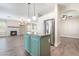 Kitchen island with granite countertops, stainless steel appliances, and open floor plan with fireplace and lots of natural light at 190 Tall Ruff Dr, Las Vegas, NV 89148
