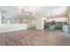 Spacious open-concept living room features wood floors and a combined kitchen area with modern appliances at 190 Tall Ruff Dr, Las Vegas, NV 89148