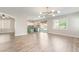 Bright and airy living room featuring wood floors, recessed lighting, and access to the backyard patio at 190 Tall Ruff Dr, Las Vegas, NV 89148