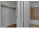 A combined bath and shower next to the wardrobe with beige tile and assistance bar at 201 Mission Laguna Ln # 104, Las Vegas, NV 89107