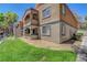 Multi-story condo building featuring stucco exterior and private balconies overlooking landscaped grounds at 201 Mission Laguna Ln # 104, Las Vegas, NV 89107