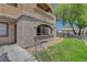 Condo exterior featuring stucco, private balcony, and landscaped grounds at 201 Mission Laguna Ln # 104, Las Vegas, NV 89107