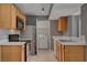 Bright kitchen with stainless steel appliances and adjacent laundry area at 201 Mission Laguna Ln # 104, Las Vegas, NV 89107