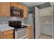 Kitchen with stainless steel appliances and adjacent laundry area at 201 Mission Laguna Ln # 104, Las Vegas, NV 89107
