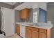 Well-lit kitchen featuring wood cabinets and stainless steel sink at 201 Mission Laguna Ln # 104, Las Vegas, NV 89107