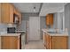 Well-equipped kitchen with stainless appliances, tile flooring, and wooden cabinets at 201 Mission Laguna Ln # 104, Las Vegas, NV 89107