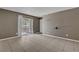 Open living room with neutral walls and tile floors, brightened by natural light at 201 Mission Laguna Ln # 104, Las Vegas, NV 89107