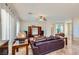 Bright living room with tile flooring, comfortable furnishings, and large windows at 2148 Shadow Canyon Dr, Henderson, NV 89044
