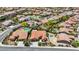 A high angle shows a neighborhood with well-maintained homes and a lush, green landscape with terracotta roofs at 2175 Sandstone Cliffs Dr, Henderson, NV 89044