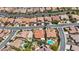 Expansive aerial perspective featuring a residential area with desert landscaping and diverse home styles at 2175 Sandstone Cliffs Dr, Henderson, NV 89044