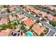 Stunning aerial view of a vibrant community showcasing well-maintained homes with pools and lush landscaping at 2175 Sandstone Cliffs Dr, Henderson, NV 89044
