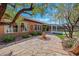 Backyard features a covered patio, lush greenery, and a beautiful stone pathway at 2175 Sandstone Cliffs Dr, Henderson, NV 89044