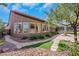 Serene backyard featuring a covered patio, lush landscaping, and a peaceful ambiance at 2175 Sandstone Cliffs Dr, Henderson, NV 89044