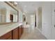 Bright bathroom featuring double sinks, soaking tub, glass block window, and tiled floors at 2175 Sandstone Cliffs Dr, Henderson, NV 89044