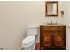 Elegant powder room featuring custom vanity with granite countertop and decorative mirror and hardware at 2175 Sandstone Cliffs Dr, Henderson, NV 89044